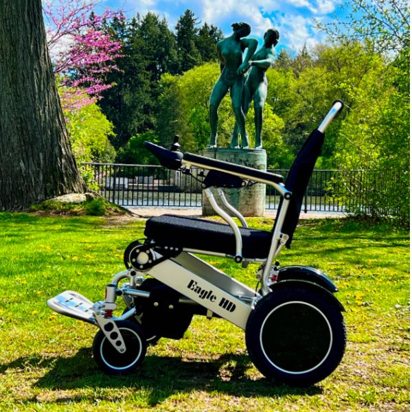 Eagle Bariatric Portable Power Wheelchair in Silver on an Outdoor Surrounding