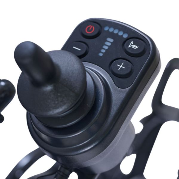 Close-up of a black joystick control with buttons and a small display, attached to a black frame against a white background.