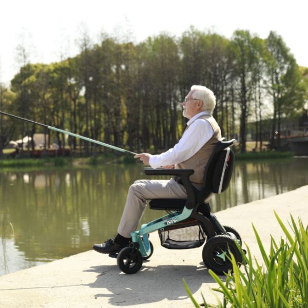 A man seating  in the Golden Ally Power Chair fishing