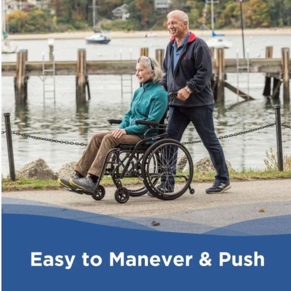 Man pushing a woman in a Journey So Lite C2 Ultra Lightweight Wheelchair by a waterfront with text &#39;Easy to Maneuver &amp; Push&#39;.