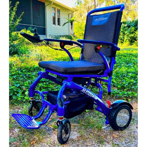 Matrix Ultra Carbon Fiber Electric Wheelchair in Blue on an Outdoor Terrain
