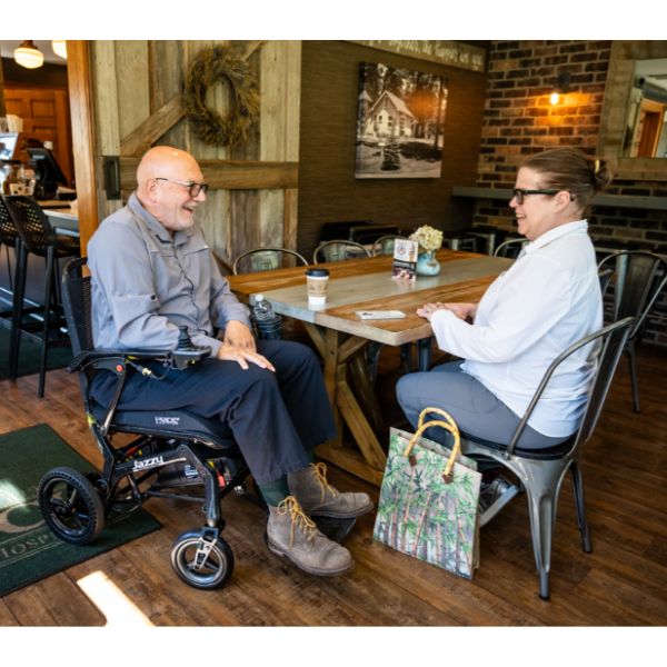 Pride Jazzy Ultra Light Folding Power Wheelchair Right Side View with Rider