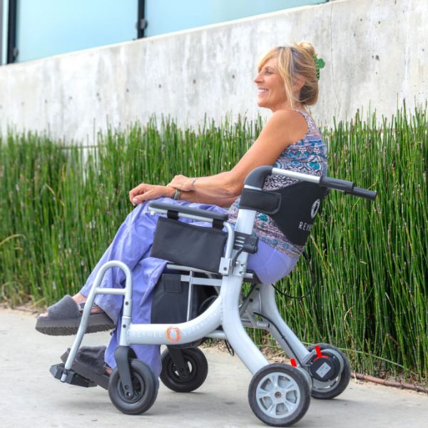 A Woman Sitting in the Reyhee Superlite Wheelchair Showing the Left Side View of the Wheelchair