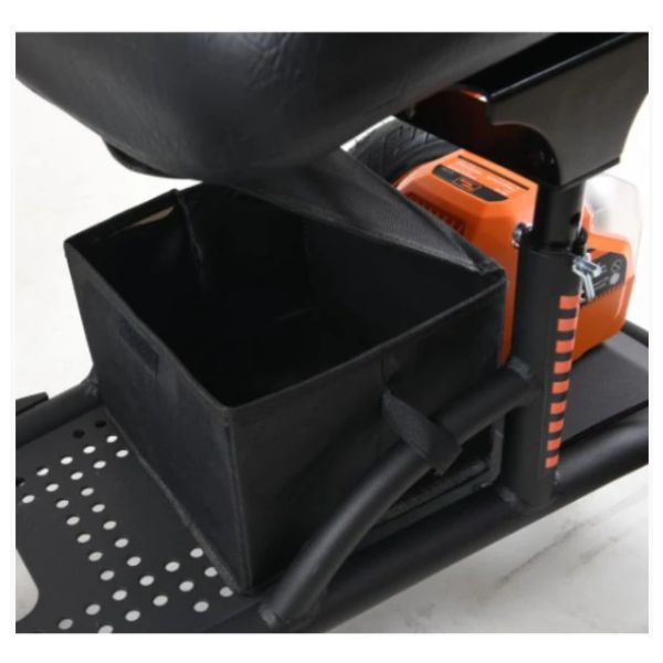 Close-up of a black storage bin attached to a piece of equipment with an orange component.
