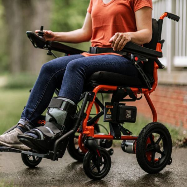 Superhandy GoRide 2 Electric Wheelchair with a Woman Riding on it