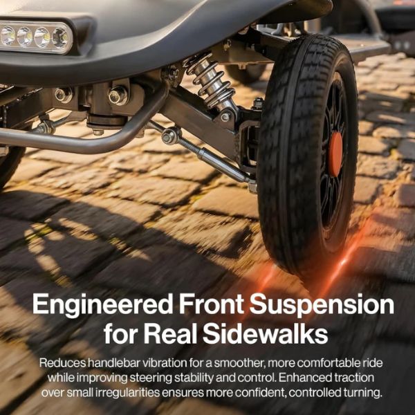 Close-up of a Superhandy Passport Flex 4-Wheel Folding Mobility Scooter front wheel and suspension system on a stone surface with text about engineered front suspension.