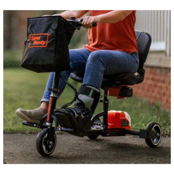 Superhandy Passport Lightweight Folding Mobility Scooter with a Woman Riding on it