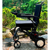 Matrix Ultra Carbon Fiber Electric Wheelchair in Black on an Outdoor Terrain