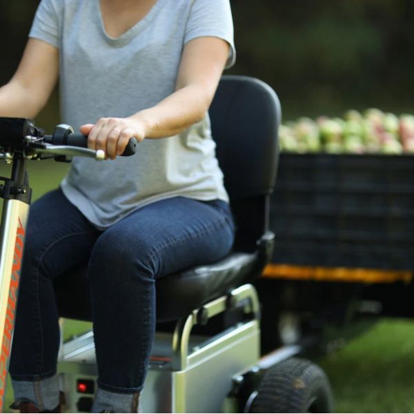 A Woman Riding on SuperHandy Electric Tugger Tow Tractor Car