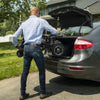 Man puttingthe folded up Feather Lightweight Electric Scooter in the back trunk of a car